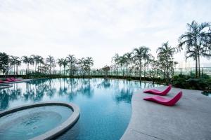 a swimming pool with pink shoes in the water at 3 Rooms Elegant Minimalist Design Setapak 15min KLCC in Kuala Lumpur