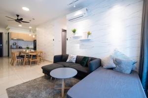 a living room with a couch and a table at 3 Rooms Elegant Minimalist Design Setapak 15min KLCC in Kuala Lumpur