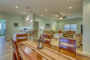 a kitchen and living room with a table and chairs at Mermaid Manor in Mexico Beach