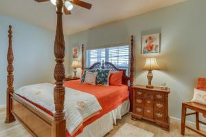 a bedroom with a canopy bed and a window at Mermaid Manor in Mexico Beach