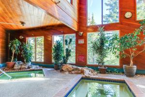 a house with a swimming pool with plants and windows at Timber Ridge Condo in Silverthorne