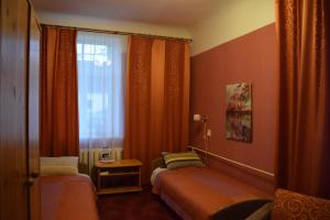 a small room with two beds and a window at Kalna Ligzda in Smiltene