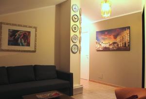 ein Wohnzimmer mit einem Sofa und Uhren an der Wand in der Unterkunft LA CASA DI NEH in Rivalba