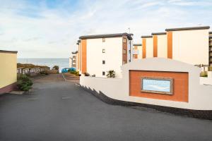 a rendering of a building with the ocean in the background at West Beach - Holiday Apartments in Westward Ho