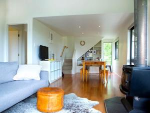 a living room with a couch and a table at Two Rooms Onetangi - Onetangi Holiday Home in Onetangi