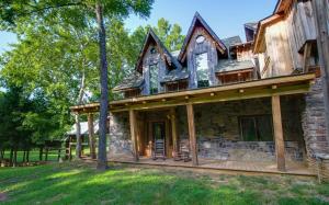 an exterior view of a log home with a roof at Charming Bunkhouse, Private Porch, Double Shower in Franklin