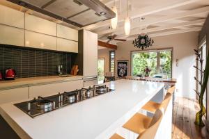 a kitchen with a white counter top and a stove at Kereru - Waiheke Holiday Home in Ostend