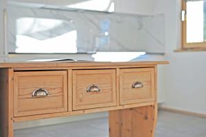 a wooden dresser with a sink in a room at Chalet n. 5 in Carano