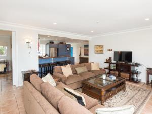 a living room with a couch and a table at Captain's Quarters - Opua Holiday Home in Opua