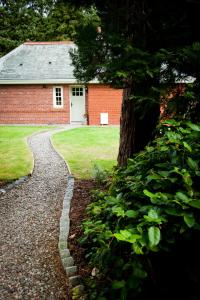 a stone path leading to a red brick building at The Gardener's Cottage in Dunblane