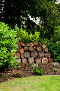 a pile of logs sitting in a garden at The Gardener's Cottage in Dunblane