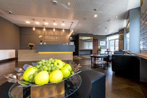 a lobby of a hotel with a bowl of fruit on a table at Rezidence Moser Apartments in Karlovy Vary