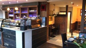a bar in a restaurant with a counter and a bar sidx sidx at Eagle Hotel Luton Airport in Luton