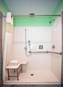 a shower with a bench in a bathroom at National 9 Motel in Santa Cruz