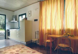a kitchen with a table and chairs in a room at Agriturismo Buranco in Monterosso al Mare