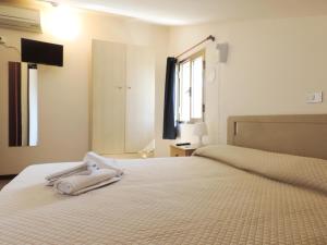 a bedroom with two beds with white towels on them at Hotel Saturno in Lido di Jesolo