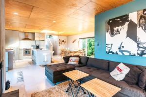 a living room with a couch and a kitchen at The Fat Pigeon - Omiha Holiday Home in Omiha