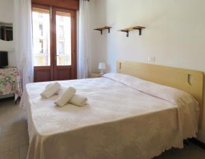 a bedroom with a bed with two towels on it at Hotel Saturno in Lido di Jesolo