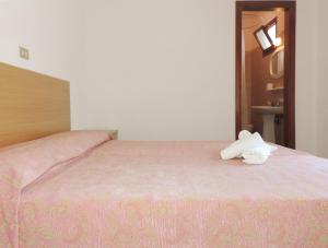 a bedroom with a bed with two towels on it at Hotel Saturno in Lido di Jesolo