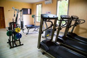 a gym with several tread machines in a room at Apartamento China Park in Domingos Martins