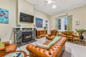 a living room with a couch and a fireplace at The Jazz B&B in Naracoorte