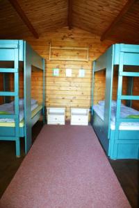 a room with two bunk beds and a red carpet at Chatová osada Na Skalkách in Nový Jičín