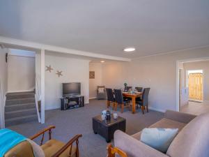 a living room with a couch and a table at Town Centre Treat - Tairua Holiday Home in Tairua