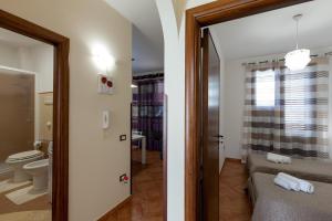 two views of a bathroom and a bedroom at B&B Le Grotte in Cinisi