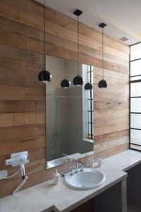 a bathroom with a sink and a mirror at La Casona Apart Boutique in Marcos Juárez +23 photos