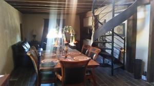 a dining room with a table and chairs and a staircase at Rancho Espinoza in Paredones