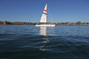 a sailboat with people on it on the water at Harbor Inn in Santa Cruz
