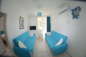 a living room with two blue couches at Side Apart Hotel in Side