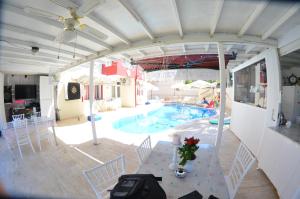 a swimming pool with a table and chairs and a table and a table at Side Apart Hotel in Side