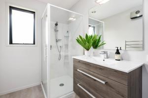 a bathroom with a sink and a shower at Albert Town Wanaka Oasis - Wanaka in Wanaka +18 photos