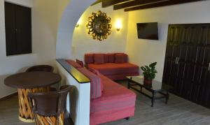 a living room with a couch and a table at Best Western Plus Posada de Don Vasco in Pátzcuaro
