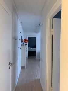 un corridoio con pareti bianche e un corridoio bianco con una camera di ApartmentInCopenhagen Apartment 1423 a Copenaghen