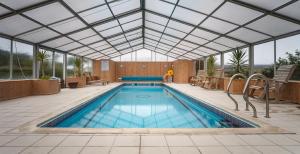 an indoor swimming pool with a glass ceiling at Star Castle Hotel in Hugh Town