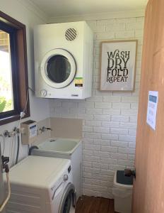 a bathroom with a washing machine and a sink at Montville Holiday Apartments in Montville