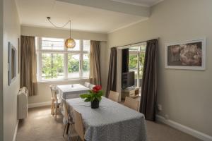 a living room with a table with flowers on it at U Studios Masterton in Masterton