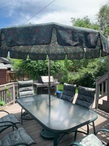 a patio table with an umbrella on a deck at Private Room in West Highlands House in Denver