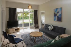 a living room with a couch and a table at U Studios Masterton in Masterton