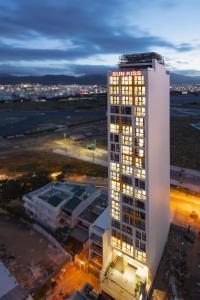 a tall white building with lights on top of it at Sun Kiss Hotel in Nha Trang