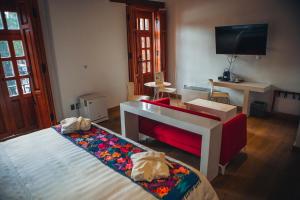 a bedroom with a bed and a television at Domingo Santo Hotel Boutique in Mexico City