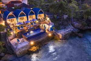 an aerial view of a house with a pool of water at Aqua Vista Villa in Nusa Lembongan