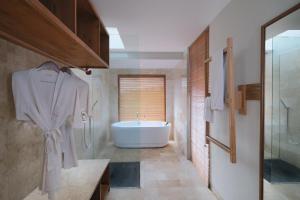 a bathroom with a shower, sink, and toilet at Puri Sebali Resort in Ubud