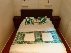 a bed with two sheets and two papers on it at Lilyponds Holiday Park in Mapleton
