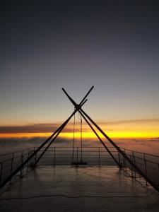 een windmolen in de oceaan met de zonsondergang op de achtergrond bij Maple map B&B in Dahu