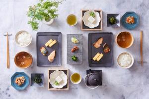 a table with plates of food and bowls of rice at Hotel Keihan Universal Tower in Osaka