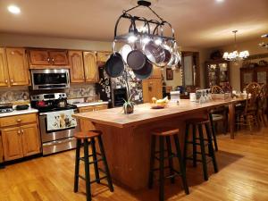 a kitchen with a large island with bar stools at Blue Ridge Manor Bed and Breakfast in Fancy Gap