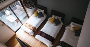 a room with three beds with pillows on them at Miyajima Shiro in Miyajima